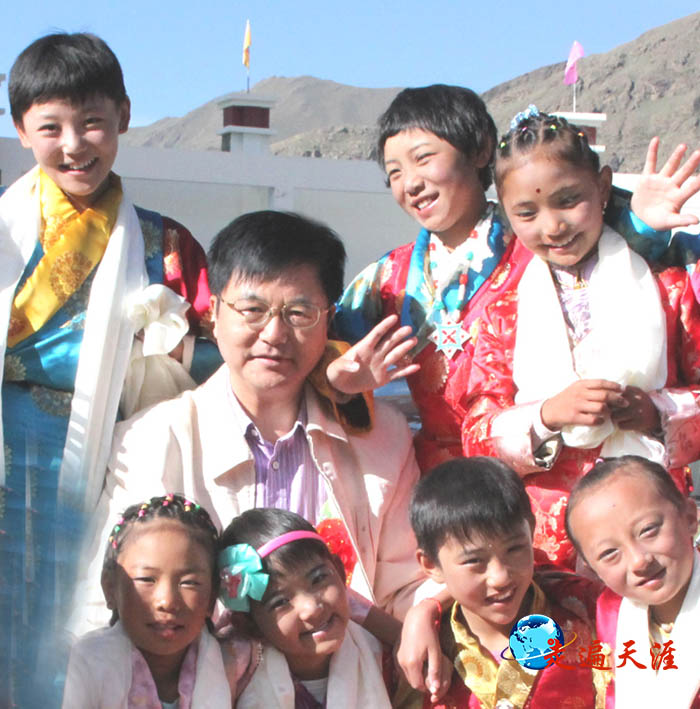 5 西藏的孩子们簇拥着《走遍天涯访关公》作者朱正明.JPG